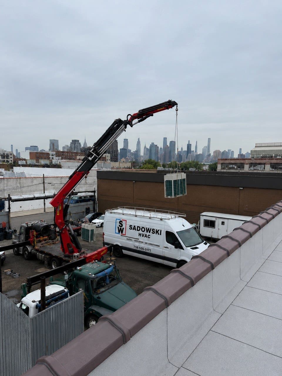 Commercial HVAC rooftop crane lift installation
