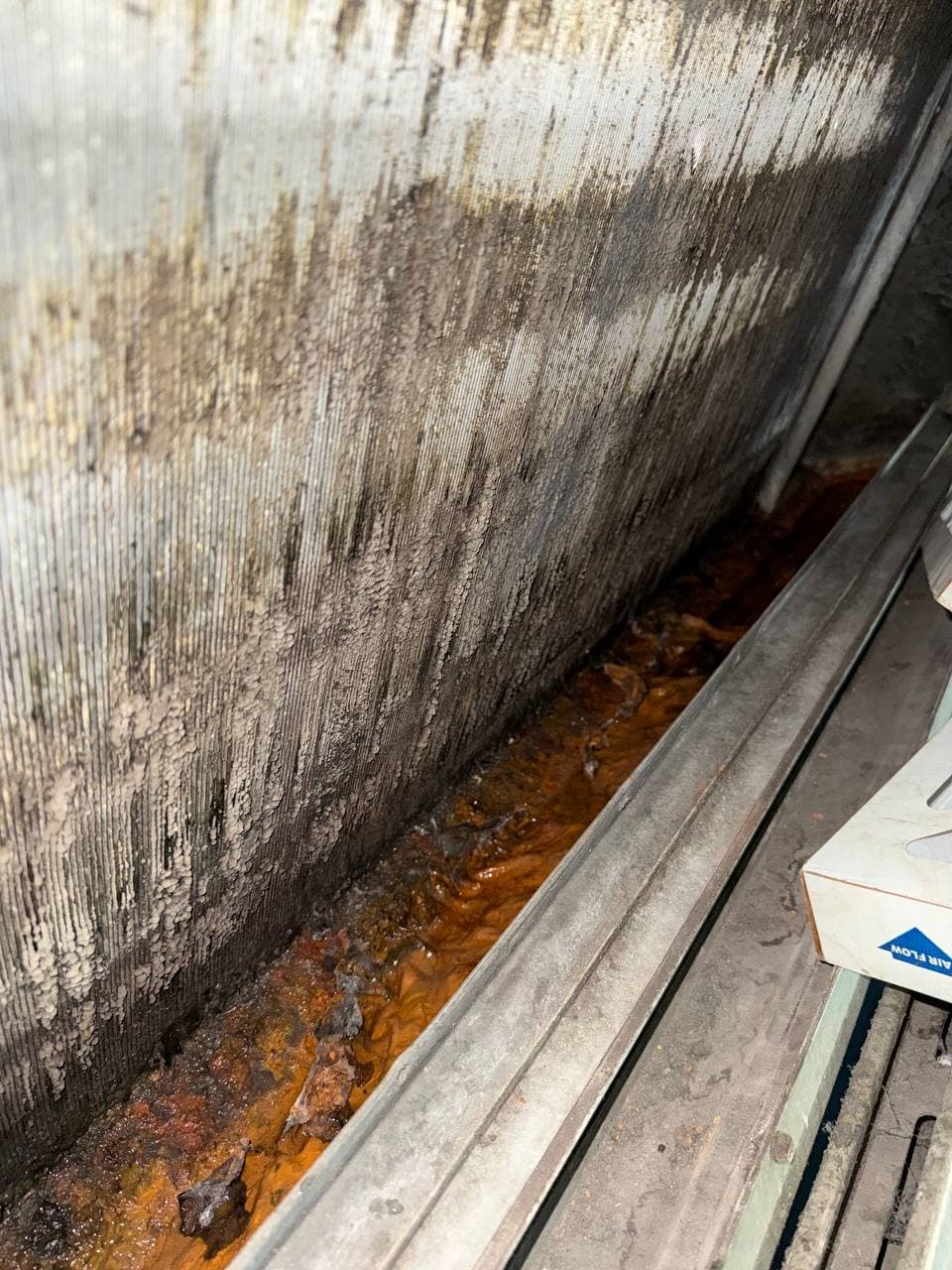 Clogged condensate tray found during commercial HVAC maintenance