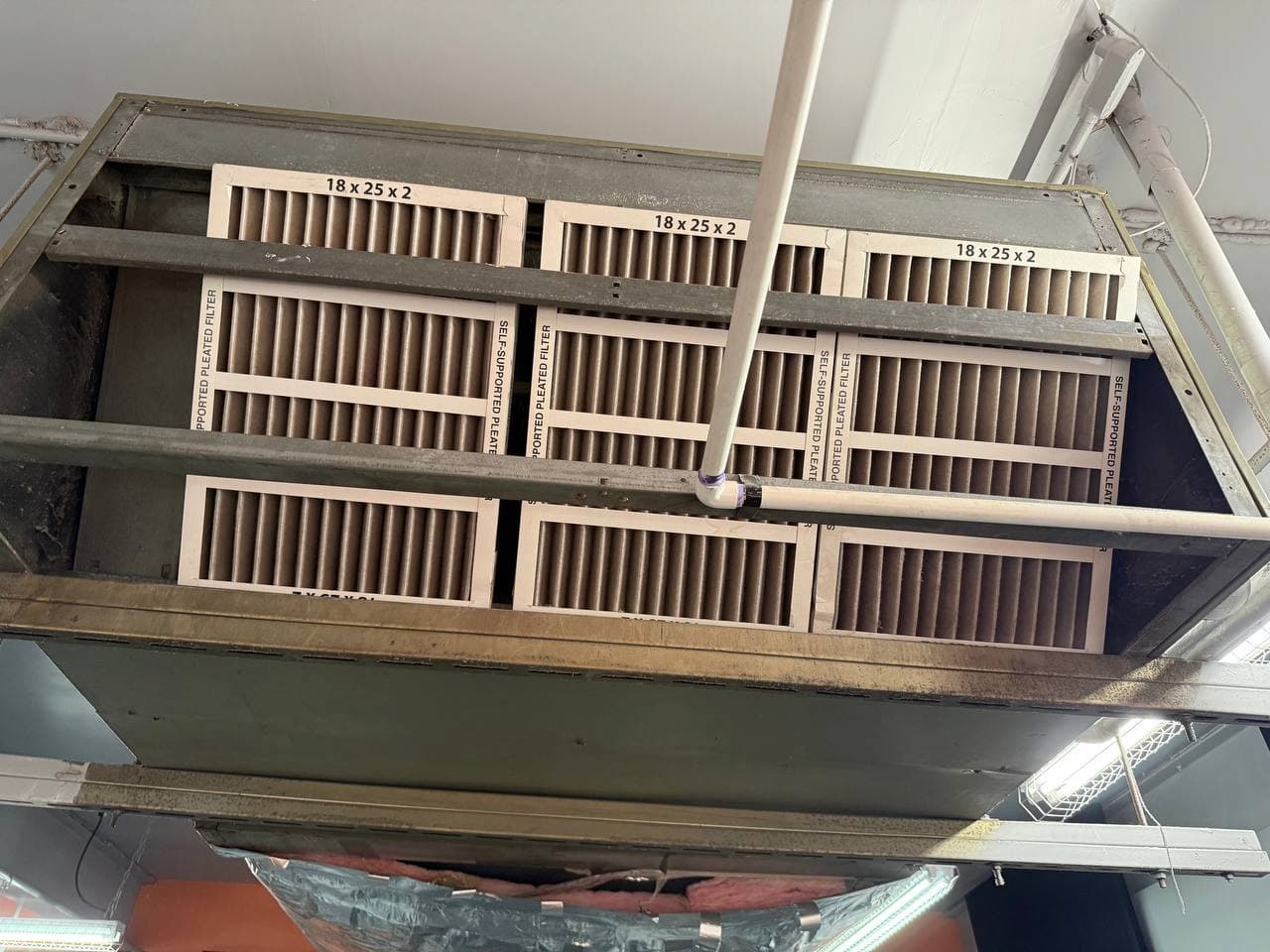 Commercial HVAC filter rack during maintenance service