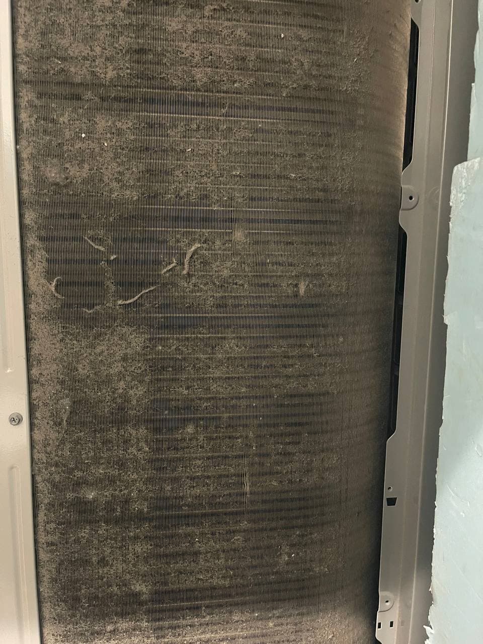 Dirty commercial HVAC coil before maintenance service