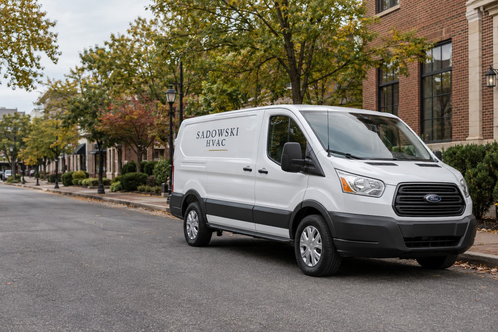 Illustrative white Sadowski HVAC service van on a tree-lined New Jersey street.